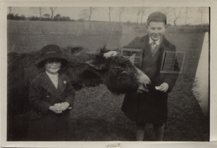 Nyria and Geoffrey with a donkey, 1924