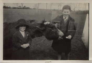 Nyria and Geoffrey with a donkey, 1924